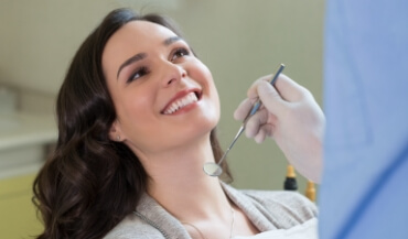 Woman smiling during preventive dentistry visit
