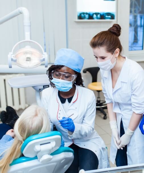 Dentist and team member providing dentistry services
