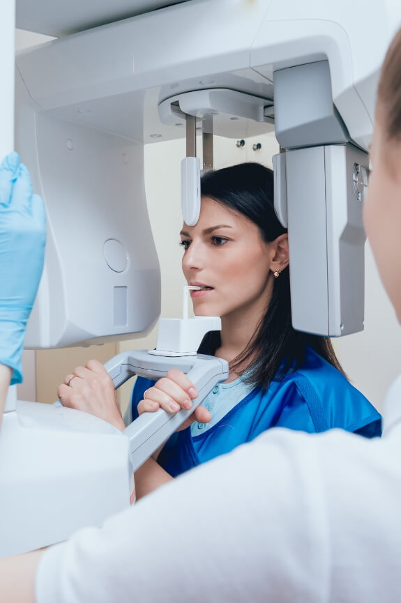 Woman receiving 3 D C T cone beam x-ray scans