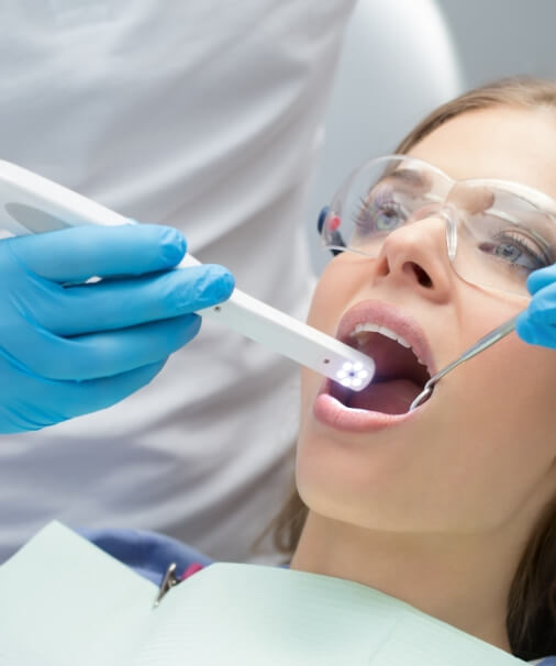 Dentist using intraoral camera to capture smile images