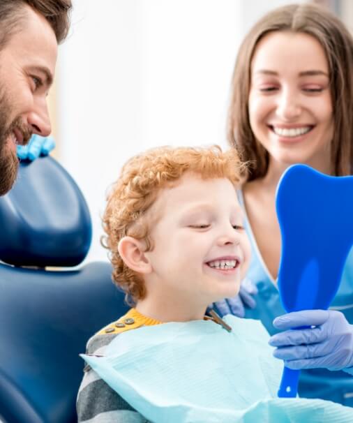 Child looking at smile in mirror