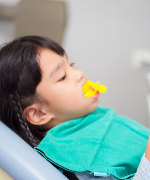 Child receiving fluoride treatment