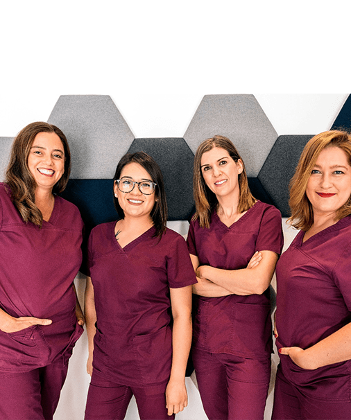 Four female dental team members smiling
