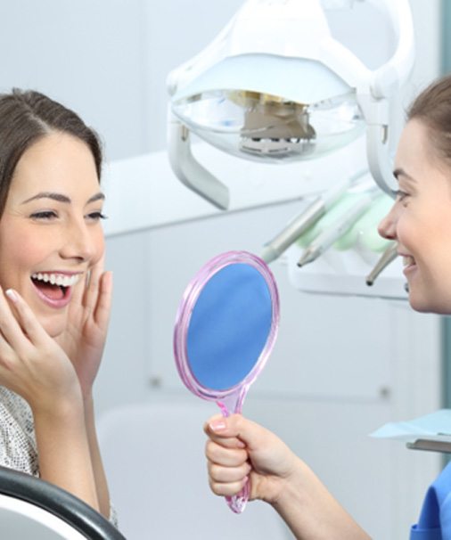 woman happy with cost of cosmetic dentistry in Newbury Park