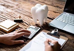 A patient filling out a dental insurance form