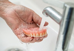 Denture is rinsed