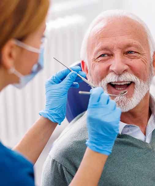 Man smiles at dentist