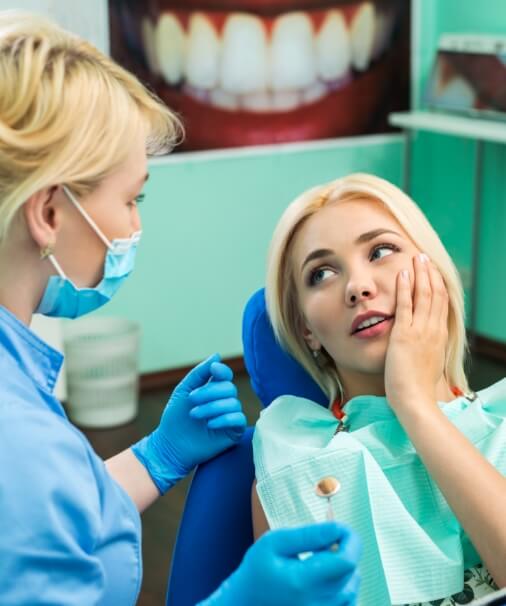 Woman discussing emergency dentistry prevention with her dentist