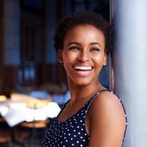 Woman smiling warmly after visiting her dental insurance dentist in Newbury Park California