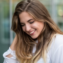 Young woman with aligned smile after Invisalign clear aligners treatment