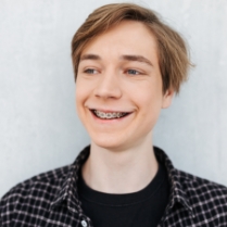 Teen boy with traditional braces smiling
