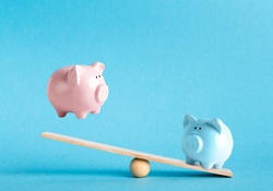 Piggy banks on balance scale