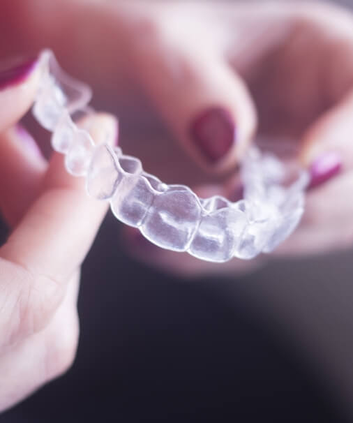Closeup of Invisalign tray in patient's hand