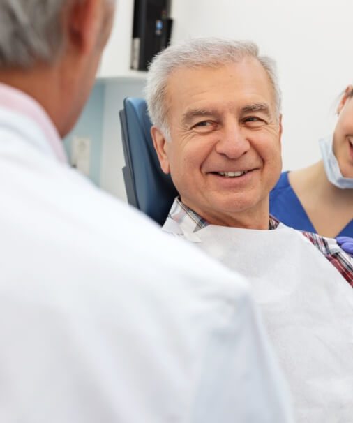 Man talking to his dentist about oral cancer screenings