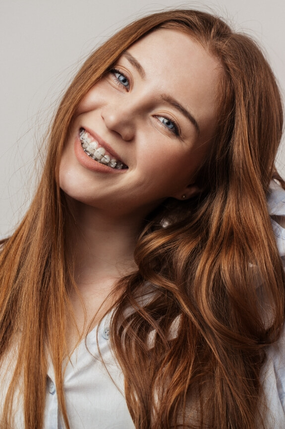 Smiling patient with traditional orthodontics