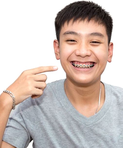 young man with braces in Newbury Park pointing to his smile