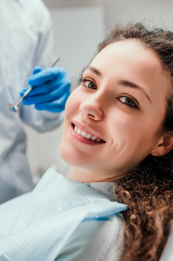 Woman smiling during preventive dentistry visit