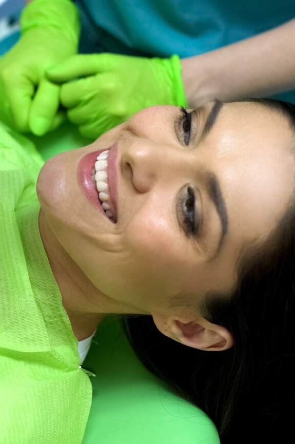 Woman smiling after receiving dental sealants