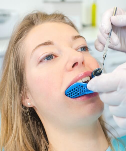 Patient receiving dental sealant treatment