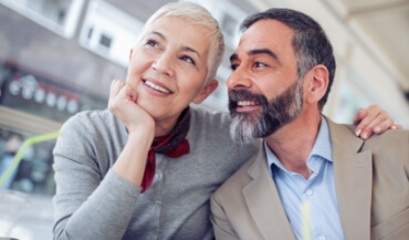 Man and woman smiling after restorative dentistry