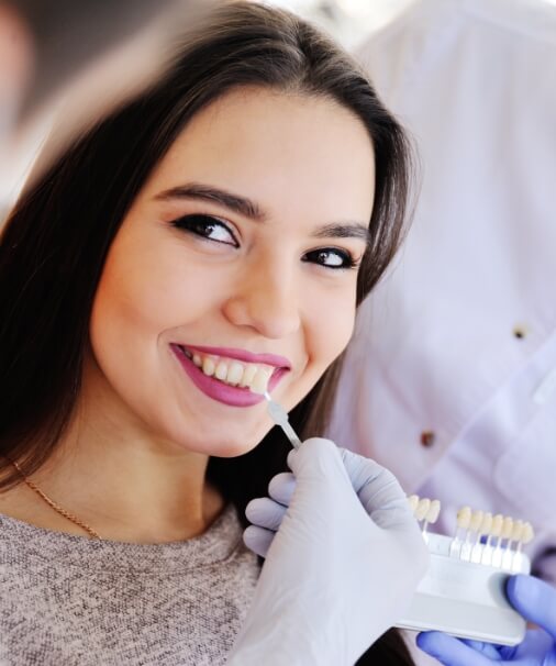 Patient smiling during porcelain veneer consultation