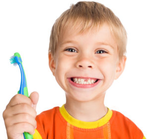 little boy smiling holding toothbrush