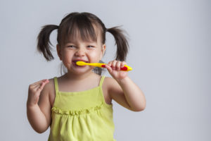 Little girl brushing her teeth. 