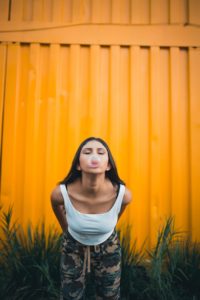 Woman blowing a bubble with chewing gum