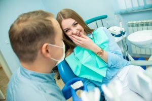 young woman smiling at her orthodontist because she’ll soon enjoy life after braces 