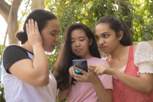 women looking at social media on smartphone 