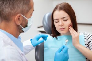Patient in pain with dentist ready to work on them. 